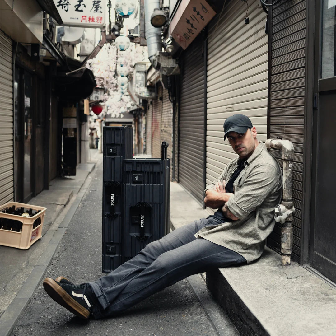 A man rests in a Tokyo alley beside the Chariot Bundle