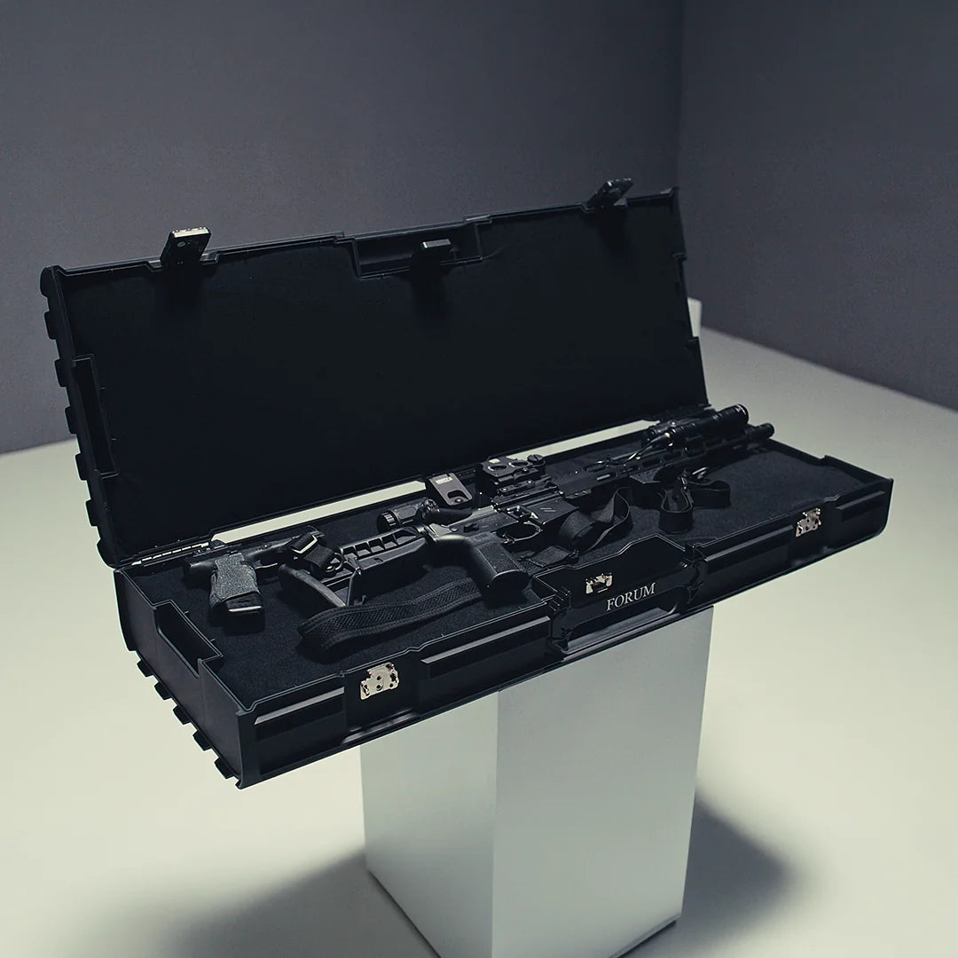 The Theseus case open on a white plinth, a rifle set in its foam