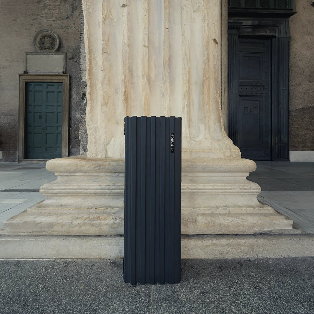 The Theseus case standing on end at the foot of a marble column